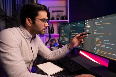 Working smart IT developer pointing data software development on pc. Surmise. Stockfoto's