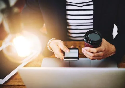 Working smartly, working efficiently. a businessman using a mobile phone and Stock Photos