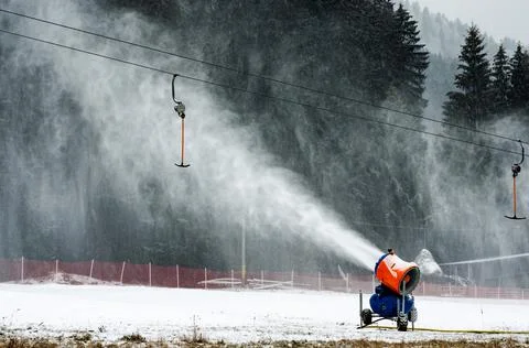 Working Snow canon on the mountain started to create snow Stock Photos
