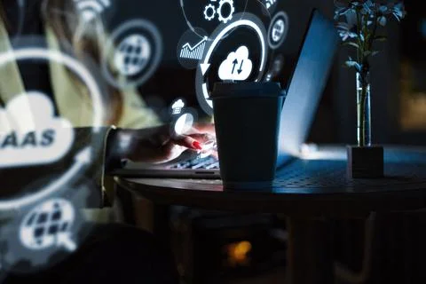 Working with software as a service in a dim room at nighttime Stock Photos
