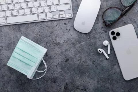 Working space with Apple computer keyboard &amp; mouse, iPhone 11 Pro Max, Airpods Stock Photos