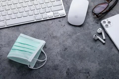 Working space with Apple computer keyboard &amp; mouse, iPhone 11 Pro Max, Airpods Stock Photos