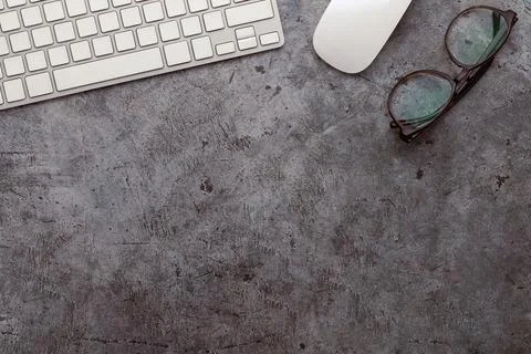 Working space with eyeglasses, computer keyboard and mouse Stock Photos