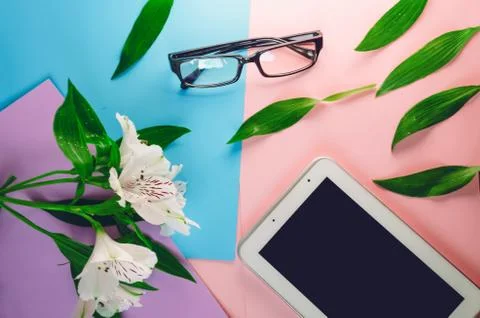 Working space . screen tablet. white alstroemeria. glasses for sight Stock Photos