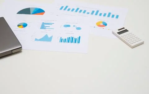 Working space table with labtop, calculator,and business chart. Foto stock