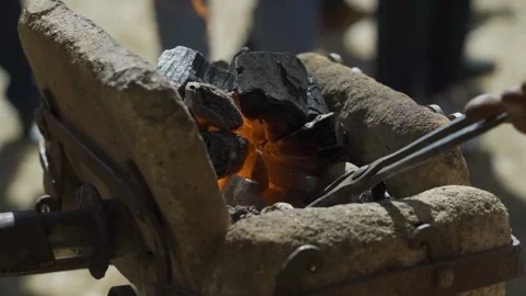 Working with split iron. A man is a blacksmith who forges iron on the street Stock Footage 250388558