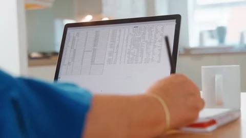 Working on Spreadsheets at Home Office in Modern Kitchen Stock Footage 281142468