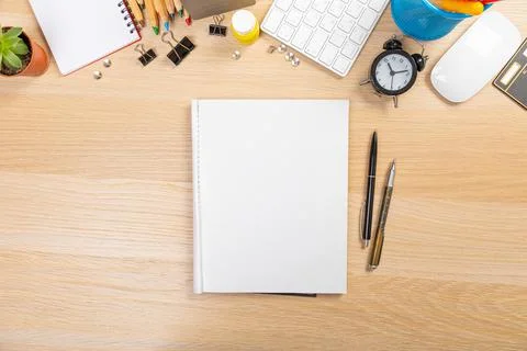 Working table with keyboard and notepad, pen, pencil and plant in home office Stock Photos