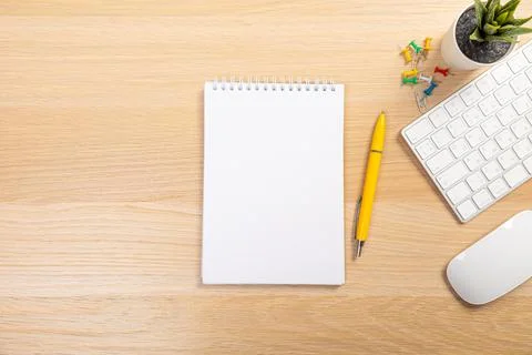 Working table with keyboard and notepad, pen, pencil and plant in home office Stock Photos