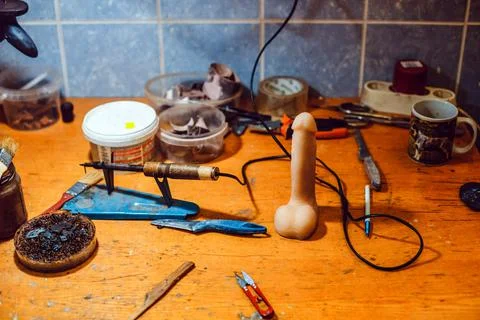 Working table of a rubber factory worker for a sex shop. Rubber penis. Stock Photos