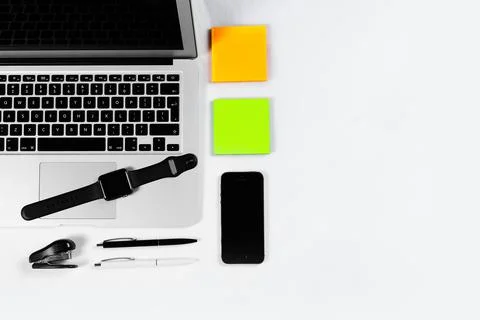 Working table top view, flat lay. Business items on a white table, laptop, cl Stock Photos