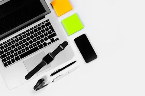 Working table top view, flat lay. Business items on a white table, laptop, cl Stock Photos