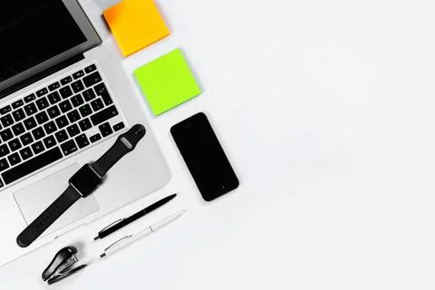 Working table top view, flat lay. Business items on a white table, laptop, cl Stock Photos