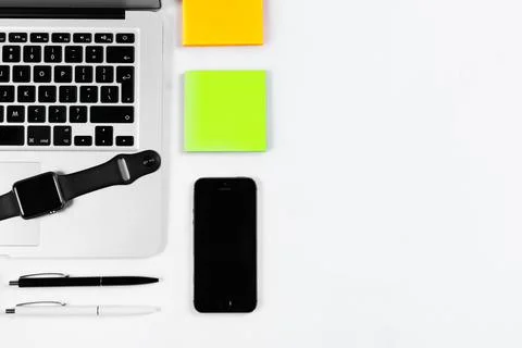 Working table top view, flat lay. Business items on a white table, laptop, cl Stock Photos