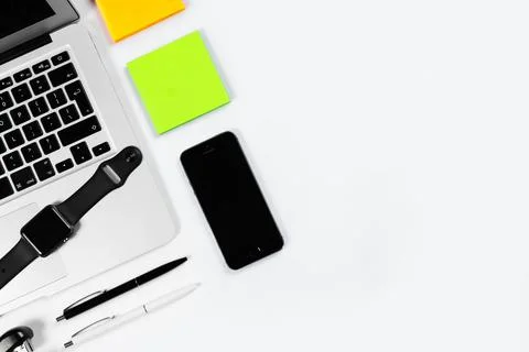 Working table top view, flat lay. Business items on a white table, laptop, cl Stock Photos