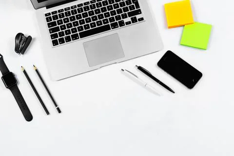 Working table top view, flat lay. Business items on a white table, laptop, cl Stock Photos