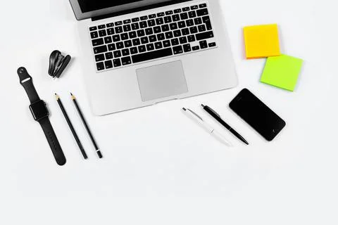 Working table top view, flat lay. Business items on a white table, laptop, cl Stock Photos