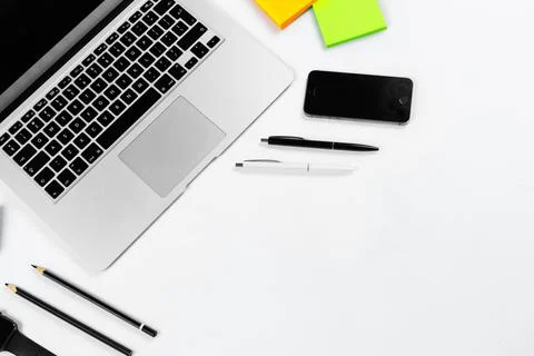 Working table top view, flat lay. Business items on a white table, laptop, cl Stock Photos