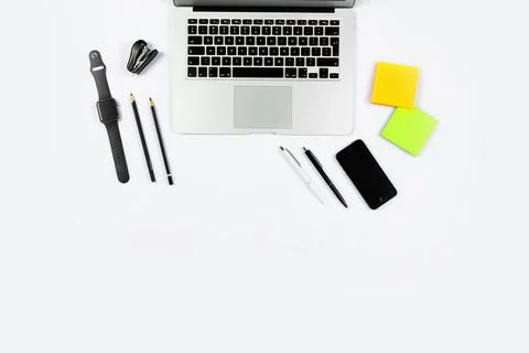 Working table top view, flat lay. Business items on a white table, laptop, cl Stock Photos