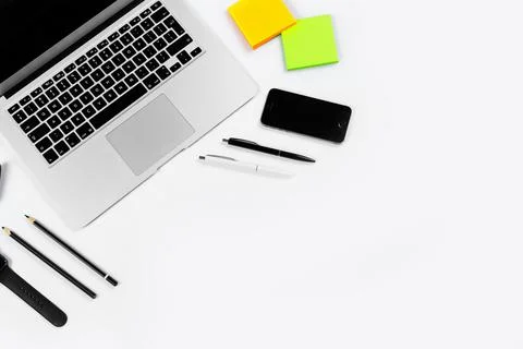 Working table top view, flat lay. Business items on a white table, laptop, cl Stock Photos