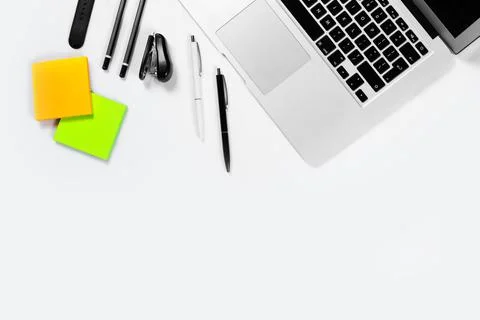 Working table top view, flat lay. Business items on a white table, laptop, pe Stock Photos