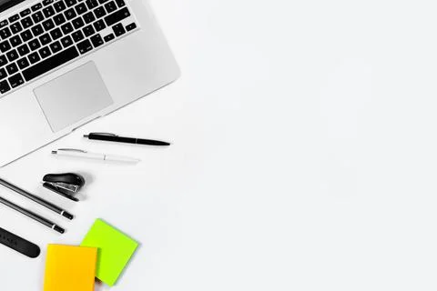 Working table top view, flat lay. Business items on a white table, laptop, cl Stock Photos