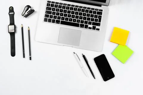 Working table top view, flat lay. Business items on a white table, laptop, cl Foto stock
