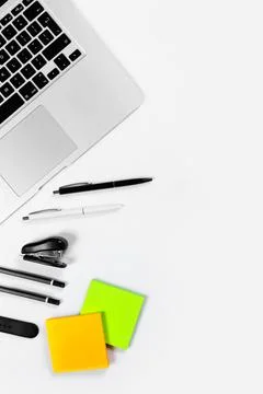 Working table top view, flat lay. Business items on a white table, laptop, pe Stock Photos