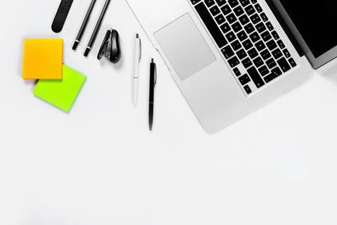 Working table top view, flat lay. Business items on a white table, laptop, pe Stock Photos