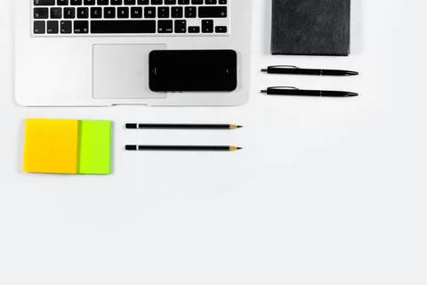 Working table top view, flat lay. Business items on a white table, laptop, pe Stock Photos