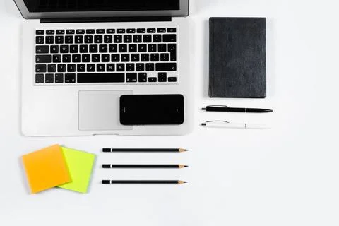 Working table top view, flat lay. Business items on a white table, laptop, pe Stock Photos