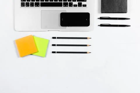 Working table top view, flat lay. Business items on a white table, laptop, pe Stock Photos
