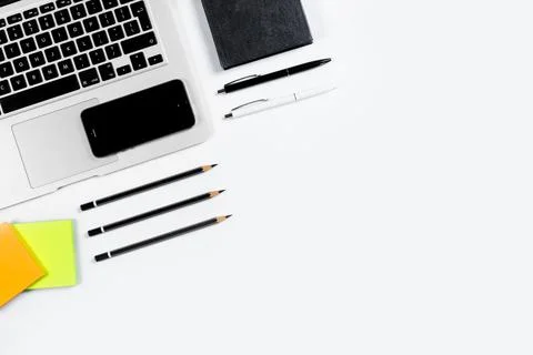 Working table top view, flat lay. Business items on a white table, laptop, pe Stock Photos