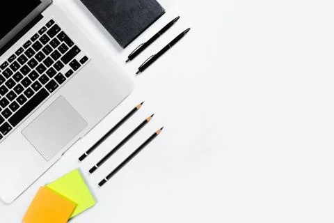 Working table top view, flat lay. Business items on a white table, laptop, pe Stock Photos