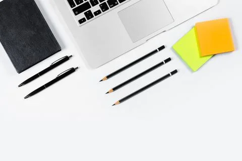 Working table top view, flat lay. Business items on a white table, laptop, pe Stock Photos