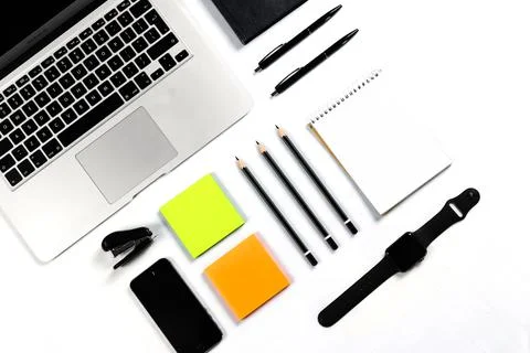 Working table top view, flat lay. Business items on a white table, laptop, cl Stock Photos