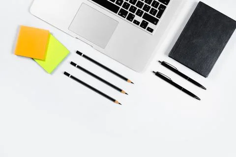 Working table top view, flat lay. Business items on a white table, laptop, pe Stock Photos