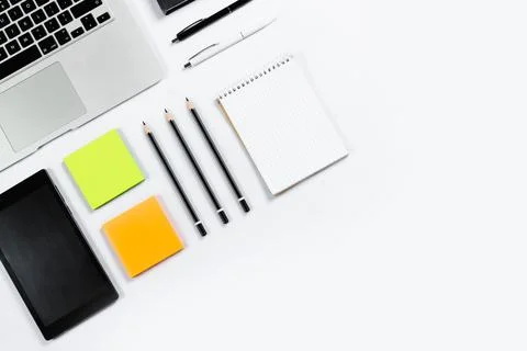 Working table top view, flat lay. Business items on a white table, laptop, cl Stock Photos
