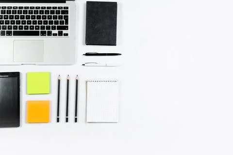 Working table top view, flat lay. Business items on a white table, laptop, cl Stock Photos