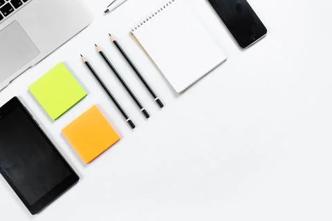 Working table top view, flat lay. Business items on a white table, laptop, cl Stock Photos