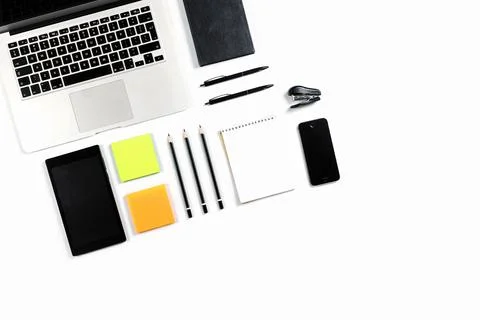 Working table top view, flat lay. Business items on a white table, laptop, cl Stock Photos