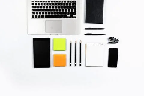Working table top view, flat lay. Business items on a white table, laptop, cl Stock Photos