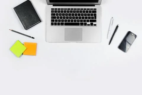 Working table top view, flat lay. Business items on a white table, laptop, cl Foto stock