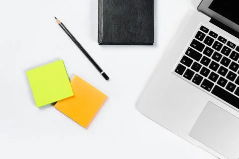 Working table top view, flat lay. Business items on a white table, laptop, cl Stock Photos