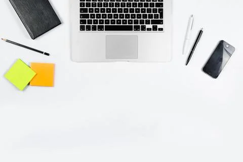 Working table top view, flat lay. Business items on a white table, laptop, cl Stock Photos