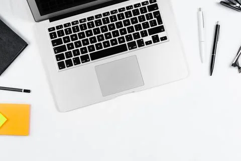 Working table top view, flat lay. Business items on a white table, laptop, cl Stock Photos