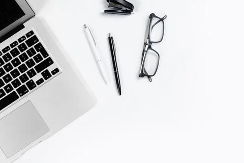 Working table top view, flat lay. Business items on a white table, laptop, cl Stock Photos