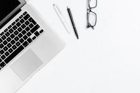 Working table top view, flat lay. Business items on a white table, laptop, cl Stock Photos