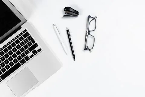 Working table top view, flat lay. Business items on a white table, laptop, cl Stock Photos