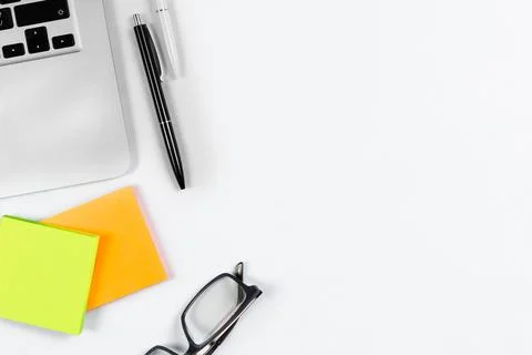 Working table top view, flat lay. Business items on a white table, laptop, cl Stock Photos